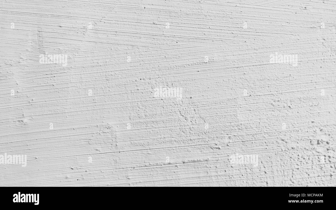 Intonaco bianco sullo sfondo della parete, configurazione astratta. Parete in cemento dipinto di bianco di close-up. Foto Stock