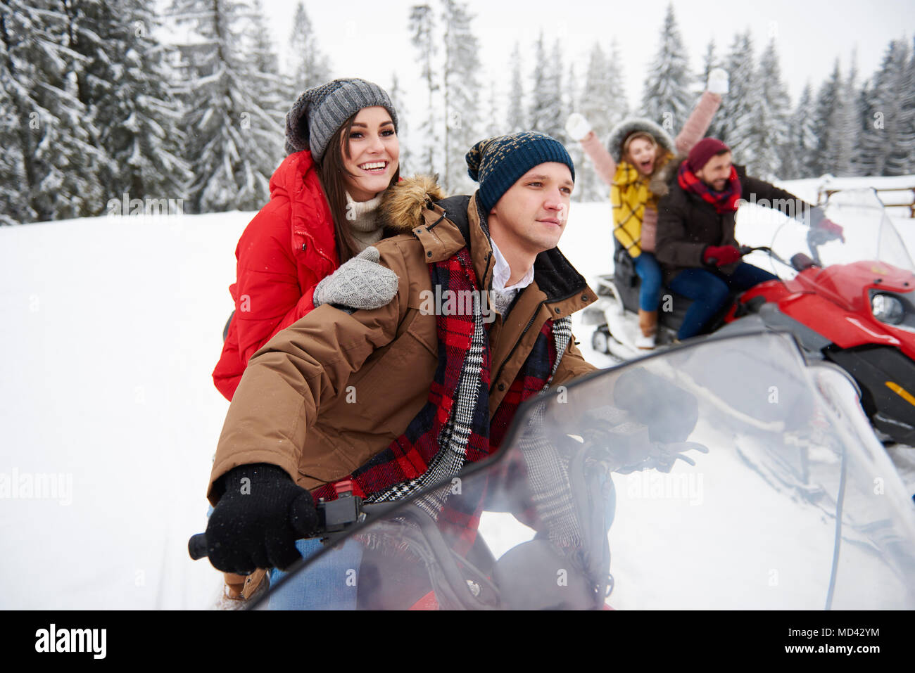 Amici a cavallo delle motoslitte in inverno Foto Stock