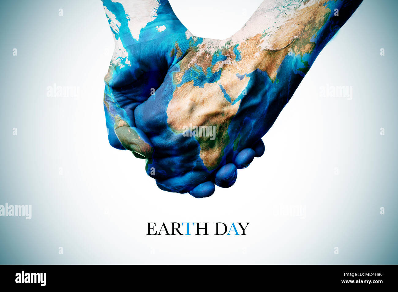 Il testo ora della terra e due persone che si tengono per mano, modellato con una mappa del mondo (arredata dalla NASA) Foto Stock