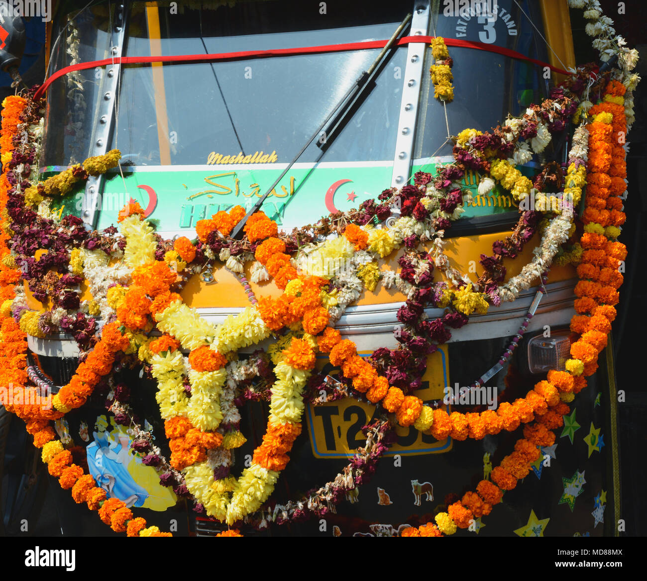 Tagete festoni ornano un tuktuk in Margao vicino a Benaulim, Goa, India Foto Stock