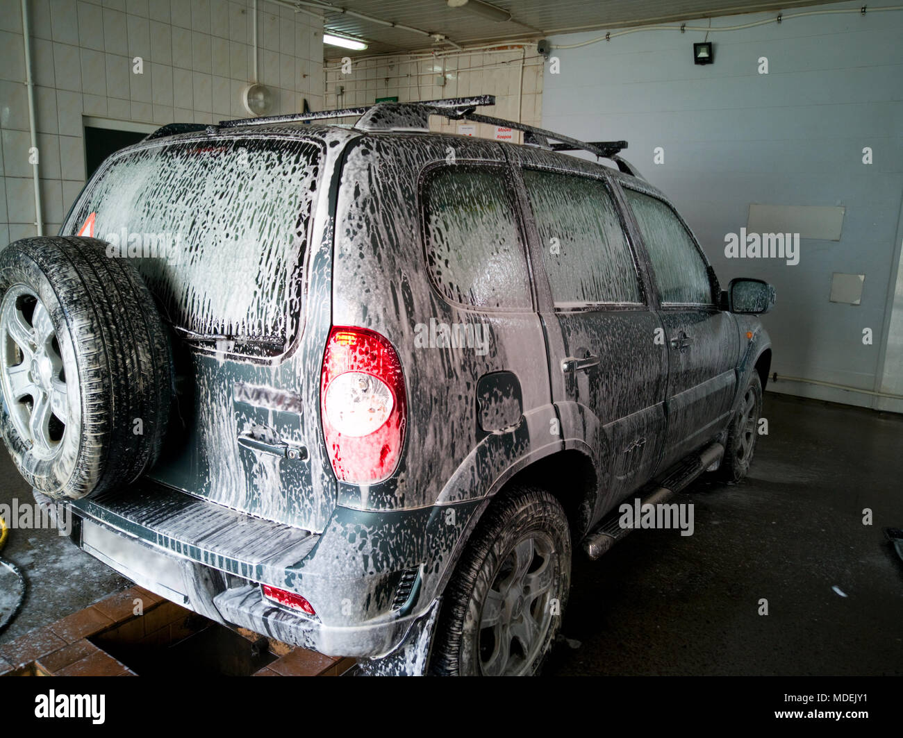 Lavaggio auto con spesse bianche di schiuma di sapone Foto Stock