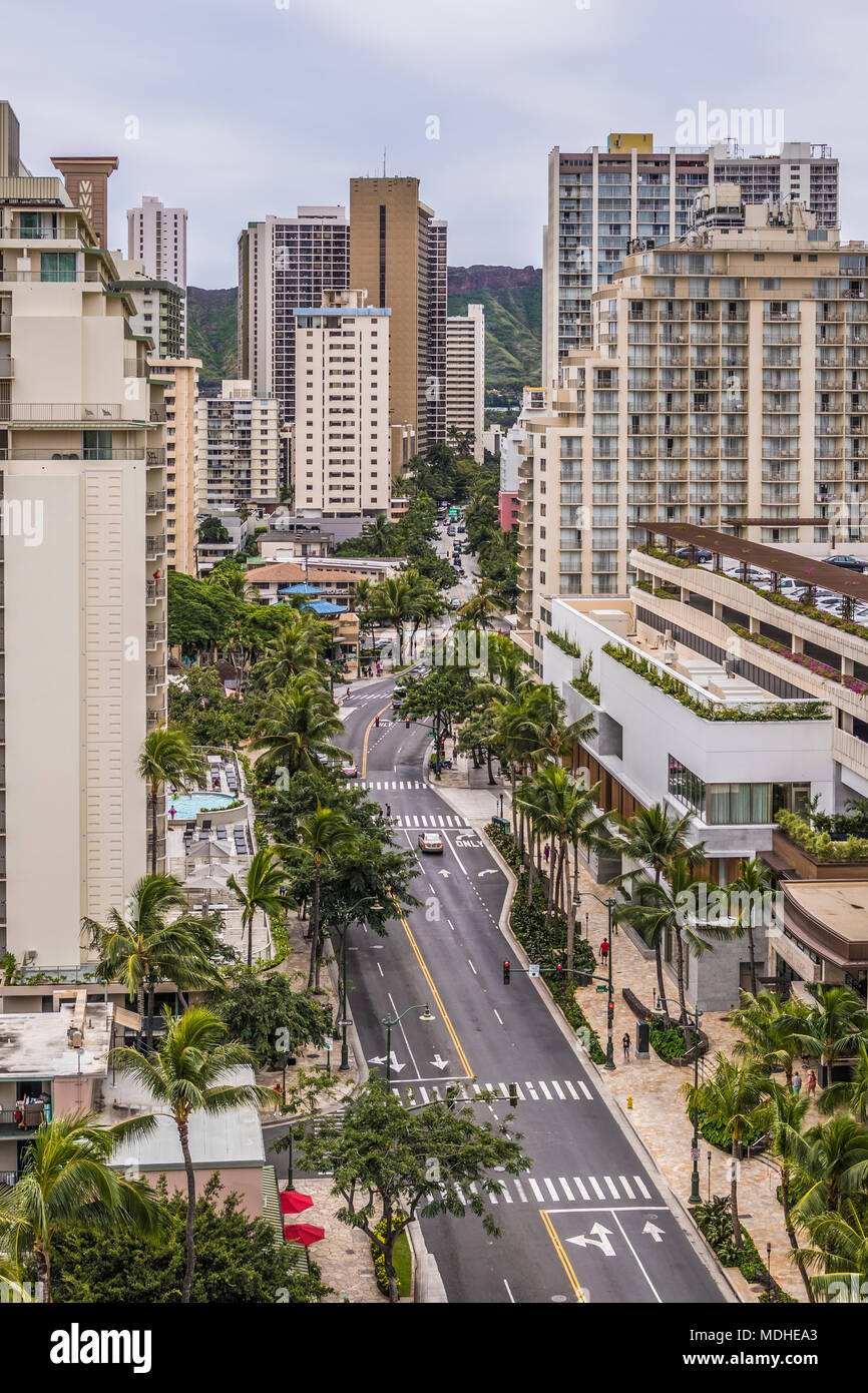 Vista verso est lungo Kuhio Avenue a Waikiki, Honolulu, Hawaii, con Diamond Head all'orizzonte visibile tra gli edifici. Il nuovo mercato internazionale ... Foto Stock