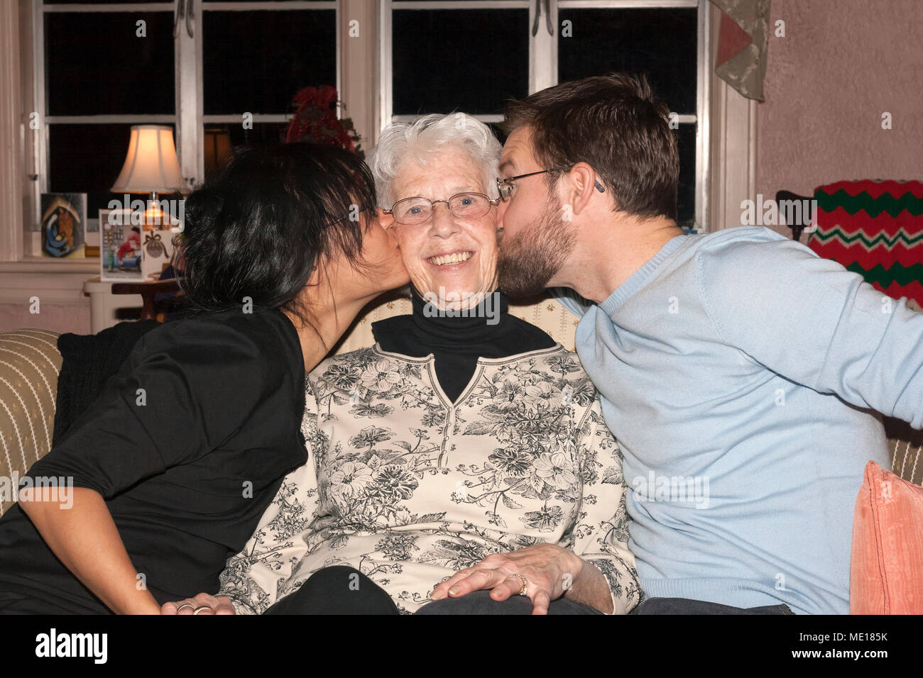 Nonna baciato dal nipote e nipote. Foto Stock