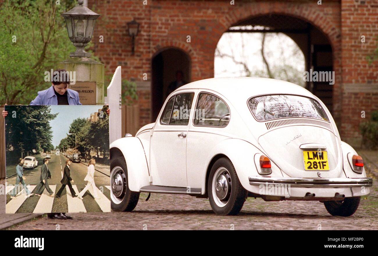 Sonja Ticehurst presenta una VW Kafer dal possesso del compianto cantante Beatle John Lennon e una foto del veicolo insieme con il british pop group sul coperchio del leggendario LP "Abbey Road' su Aprile 8, 1999 nella parte anteriore del Ahlden auction house vicino a Walsrode. Il veicolo è uno dei circa 3000 presenta dal 107th aste su 8 Maggio nel castello sull'Aller. I Beatles "Beetle' ha 150000 chilometri e dovrebbe venire sotto il martello per la chiamata prezzo di 25.000 marchi. Intorno a John Lennon's Kafer, prima del rilascio di 'Abbey Road', c'era un pazzo legenda: Paul McCartney erano di Foto Stock