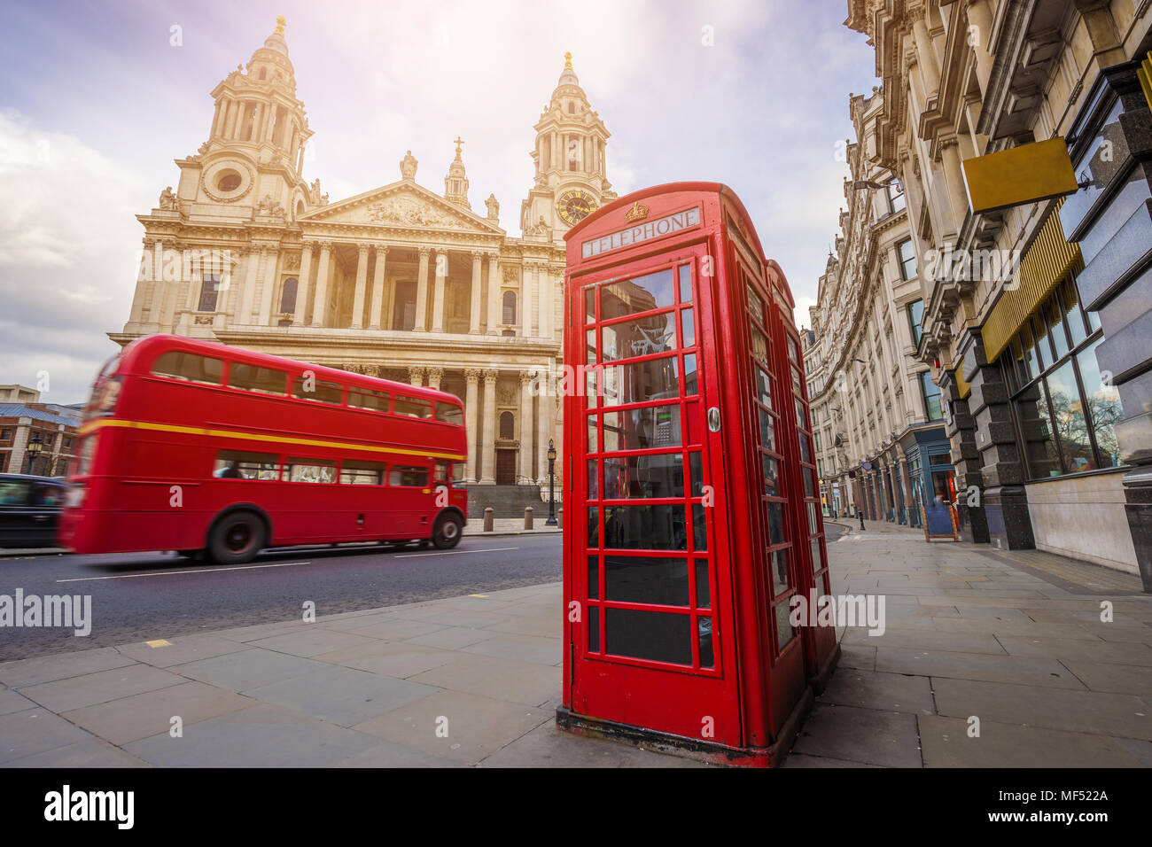 Londra, Inghilterra - tradizionale telefono rosso scatola con iconica red vintage double-decker bus sul muoversi a San Paolo in una giornata di sole Foto Stock