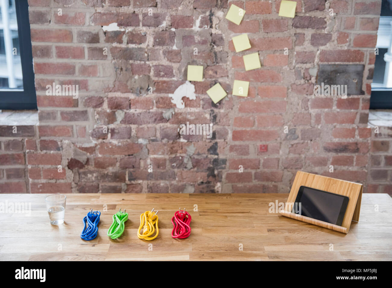 Tablet e colorate dei cavi di potenza sulla tavola di legno Foto Stock