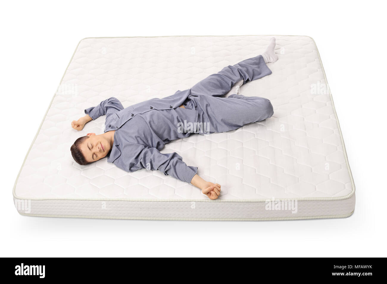 Ragazzo adolescente di dormire su un materasso isolati su sfondo bianco Foto Stock