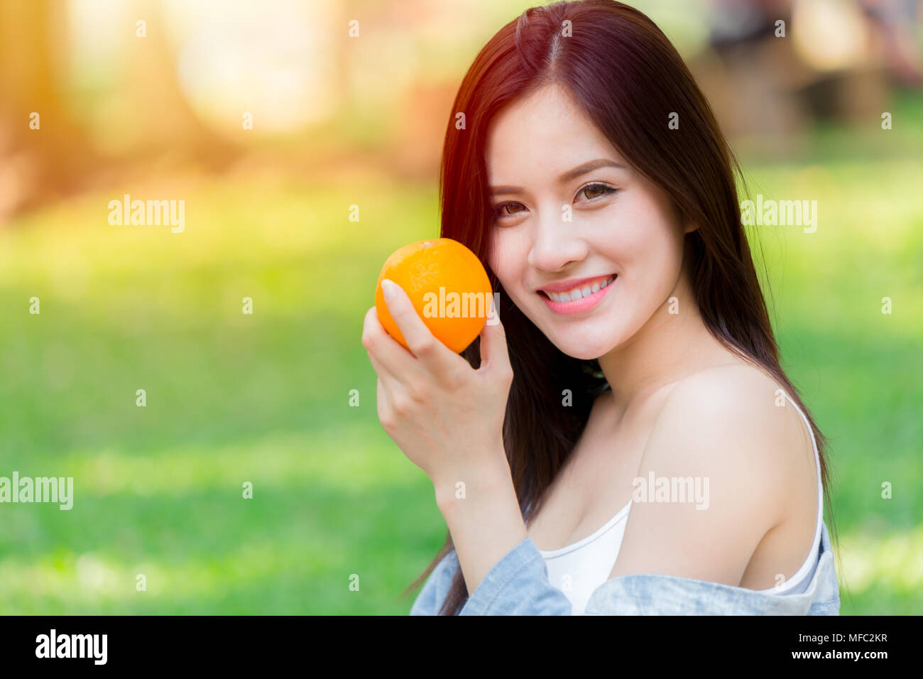 Frutta di arancia con sani donna asiatica per una buona immunità della pelle e alta vitamina C Foto Stock