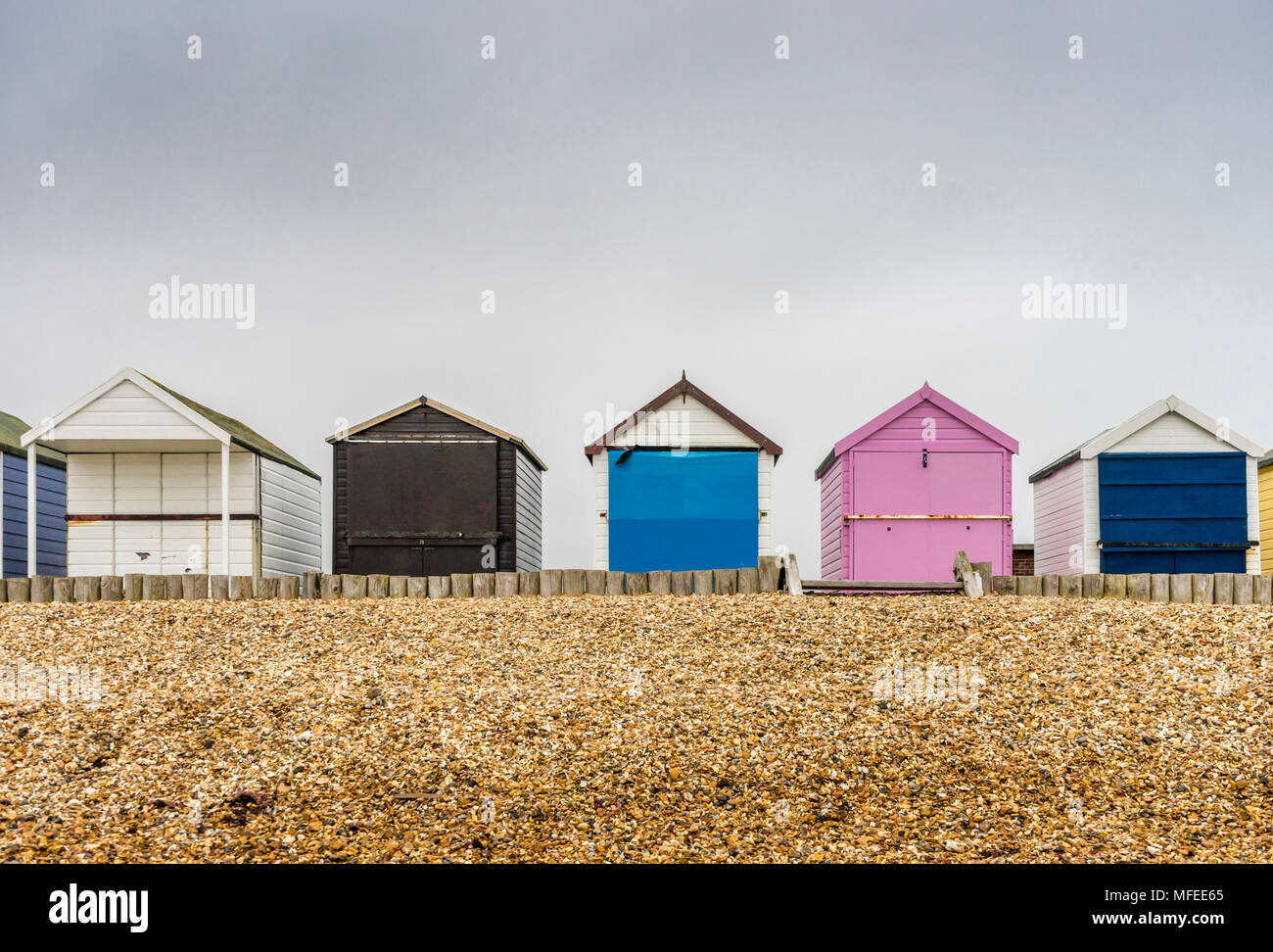 Pittoresca spiaggia di capanne lungo Calshot Spit su un nuvoloso giorno nuvoloso, Calshot, England, Regno Unito Foto Stock