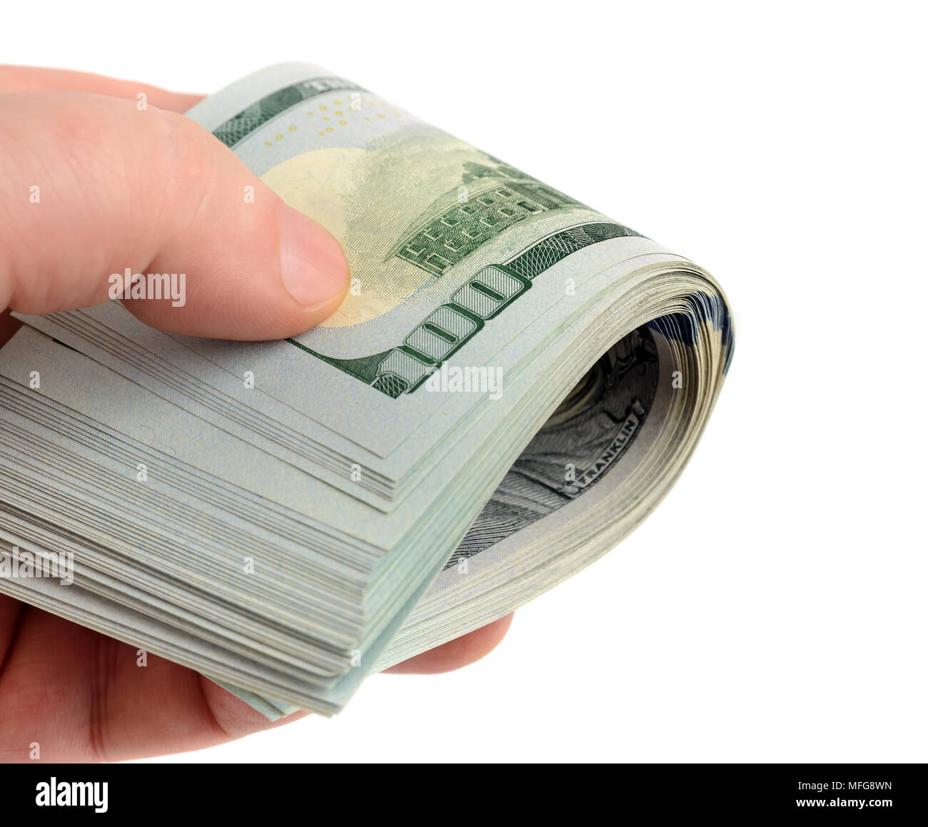 Mano con molti dollari in rotolo isolato su bianco Foto Stock