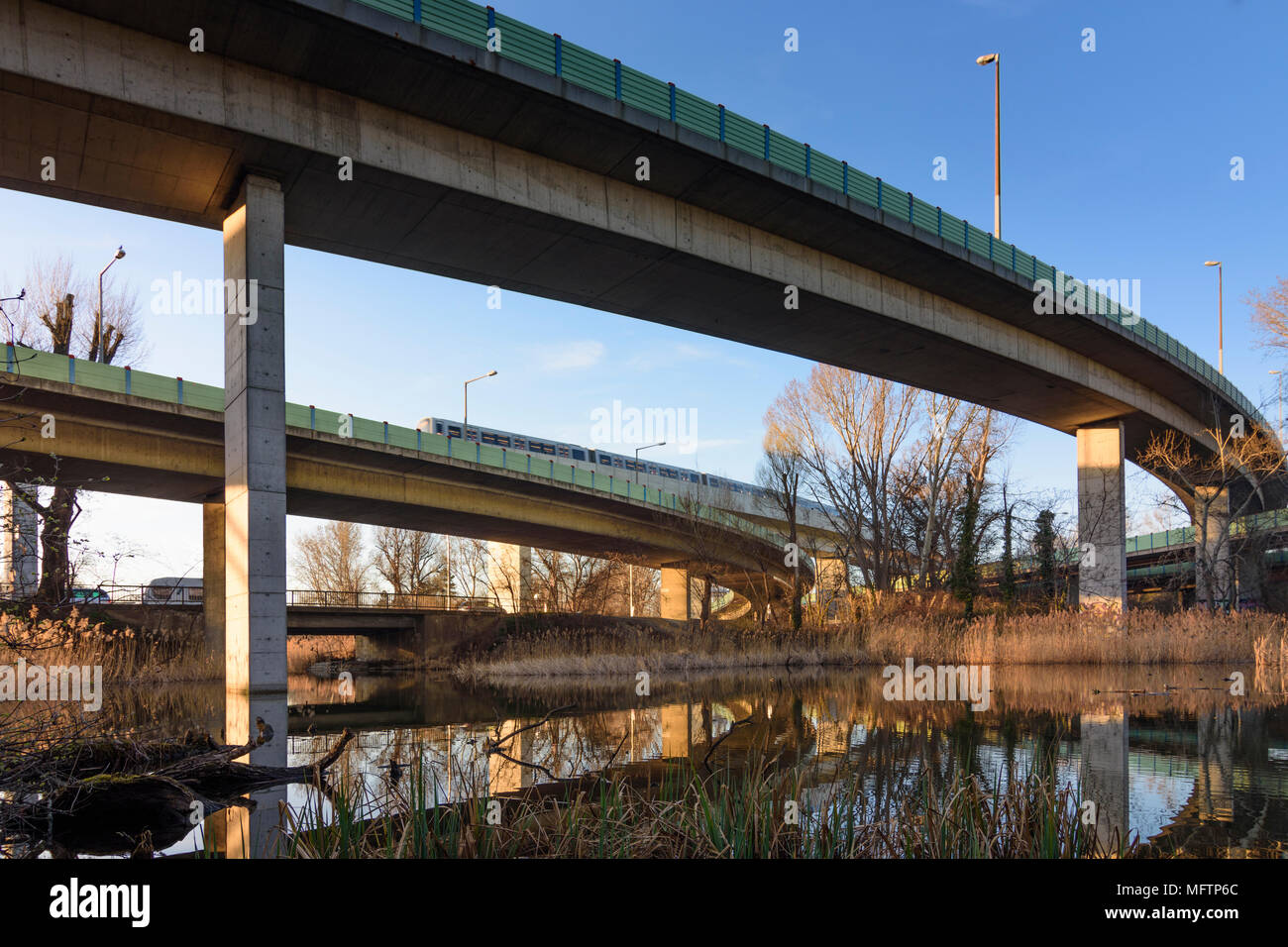 Wien, Vienna: autostrada ponti, metropolitana sopraelevata bridge, attraversato il lago Oberes Mühlwasser, terra consumo in Austria, Wien, 22. Donaustadt Foto Stock