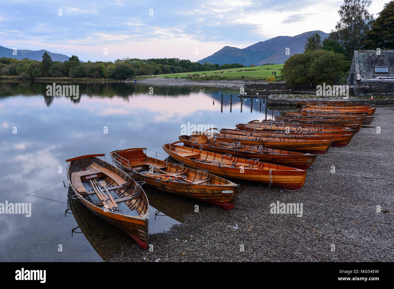 In legno barche a remi in riva a Keswick imbarcadero all'alba sulla Derwent Water nel Parco Nazionale del Distretto dei Laghi, Cumbria, Inghilterra Foto Stock