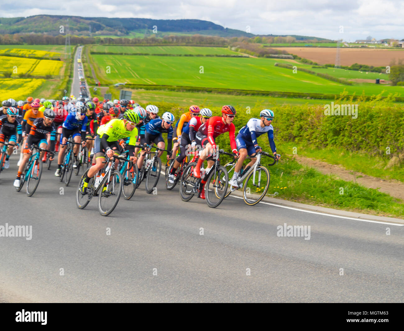 Dunsdale, UK 29 aprile 2018 Sport Est Cleveland Klondike Grand Prix un giorno di ciclo di corsa su strada ha avuto luogo oggi a copertura di un 100 miglio percorso attorno ai villaggi di East Cleveland. La gara di inizio e di fine sono nella città di Guisborough. La gara è stata neutralizzata per quanto riguarda il villaggio di Dunsdale dove la bandiera è stata interrotta e la corsa corretta è iniziato. Queste immagini mostrano i piloti subito dopo l'avvio. Credito: Pietro Giordano NE/Alamy Live News Foto Stock