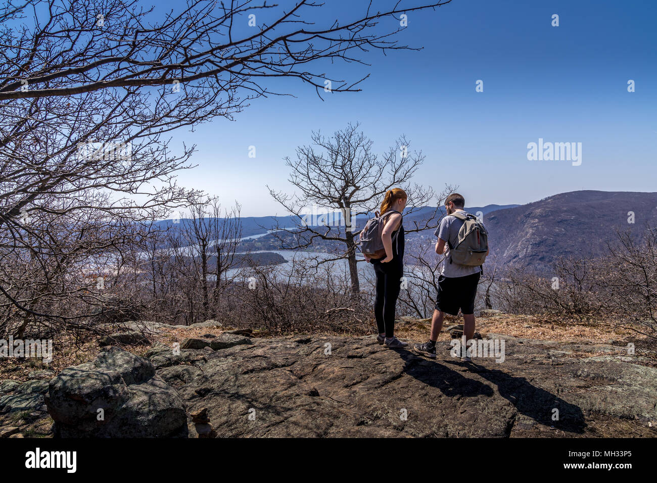 Cold Spring, NY, Stati Uniti d'America - 14 aprile 2018. Giovane si affacciano sul fiume Hudson sul sentiero escursionistico a Bull collina vicino alla città di Cold Spring, NY. Foto Stock