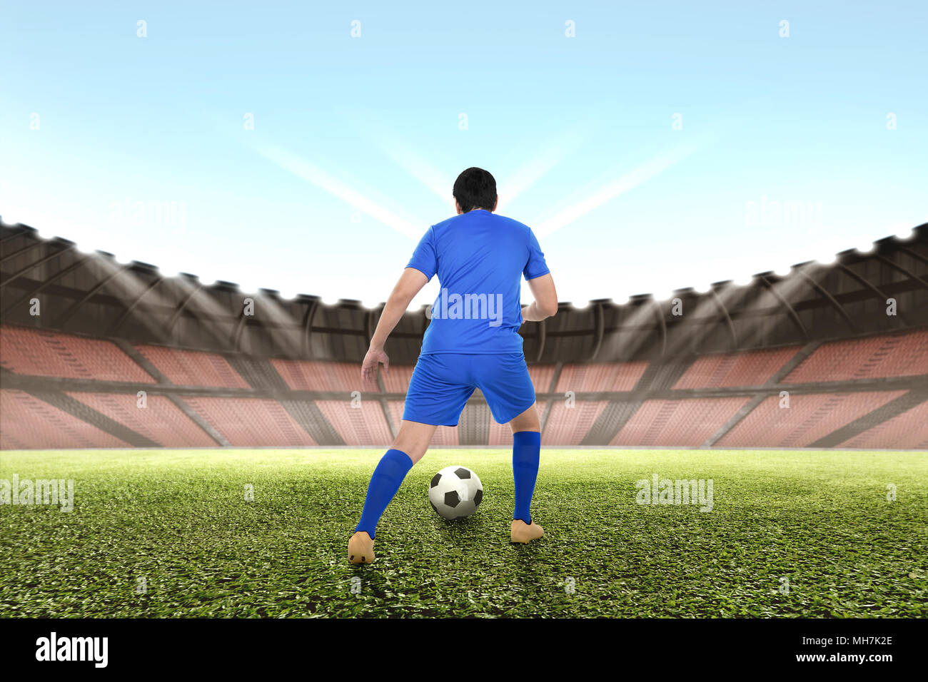 Professional asian giocatore di football dribbling la palla sul campo Foto Stock