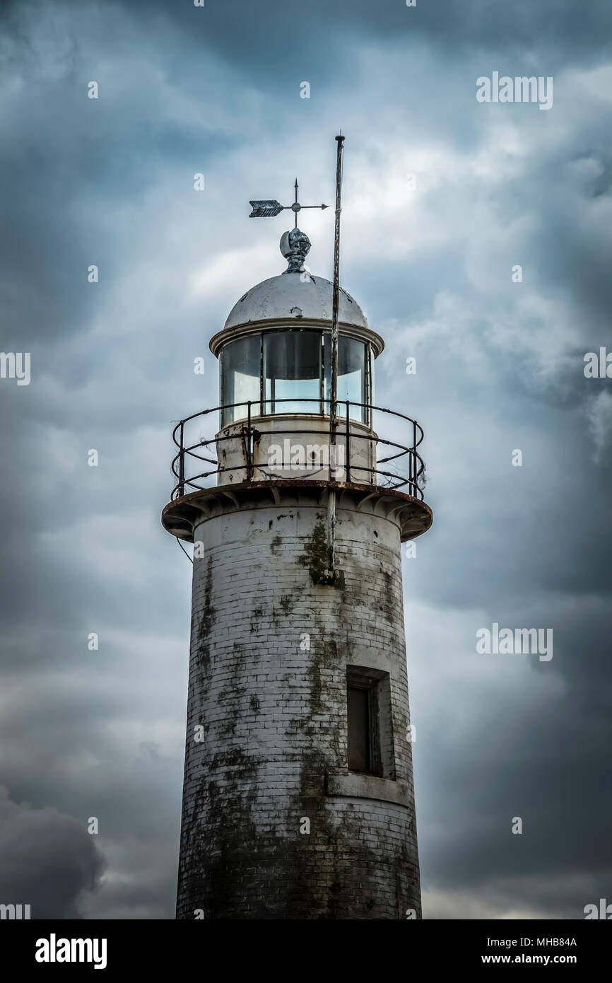 Vecchio faro con nuvole temporalesche. Hale Capo Faro Liverpool, Merseyside. Foto Stock