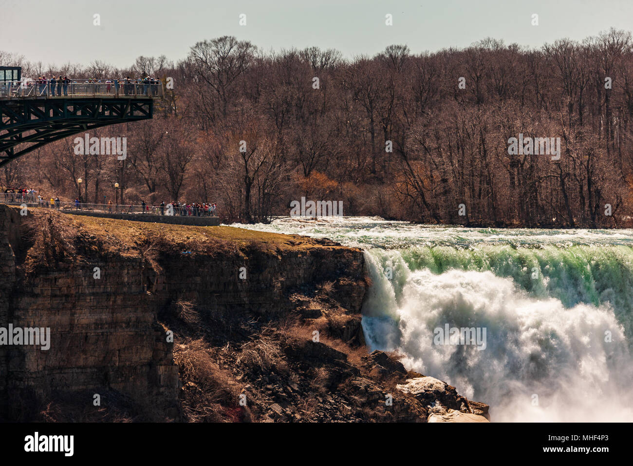I turisti in Niagara Falls, Stati Uniti d'America, vista la cresta delle Cascate del Niagara come l'acqua fa il suo modo sopra la parte superiore delle cascate. Foto Stock