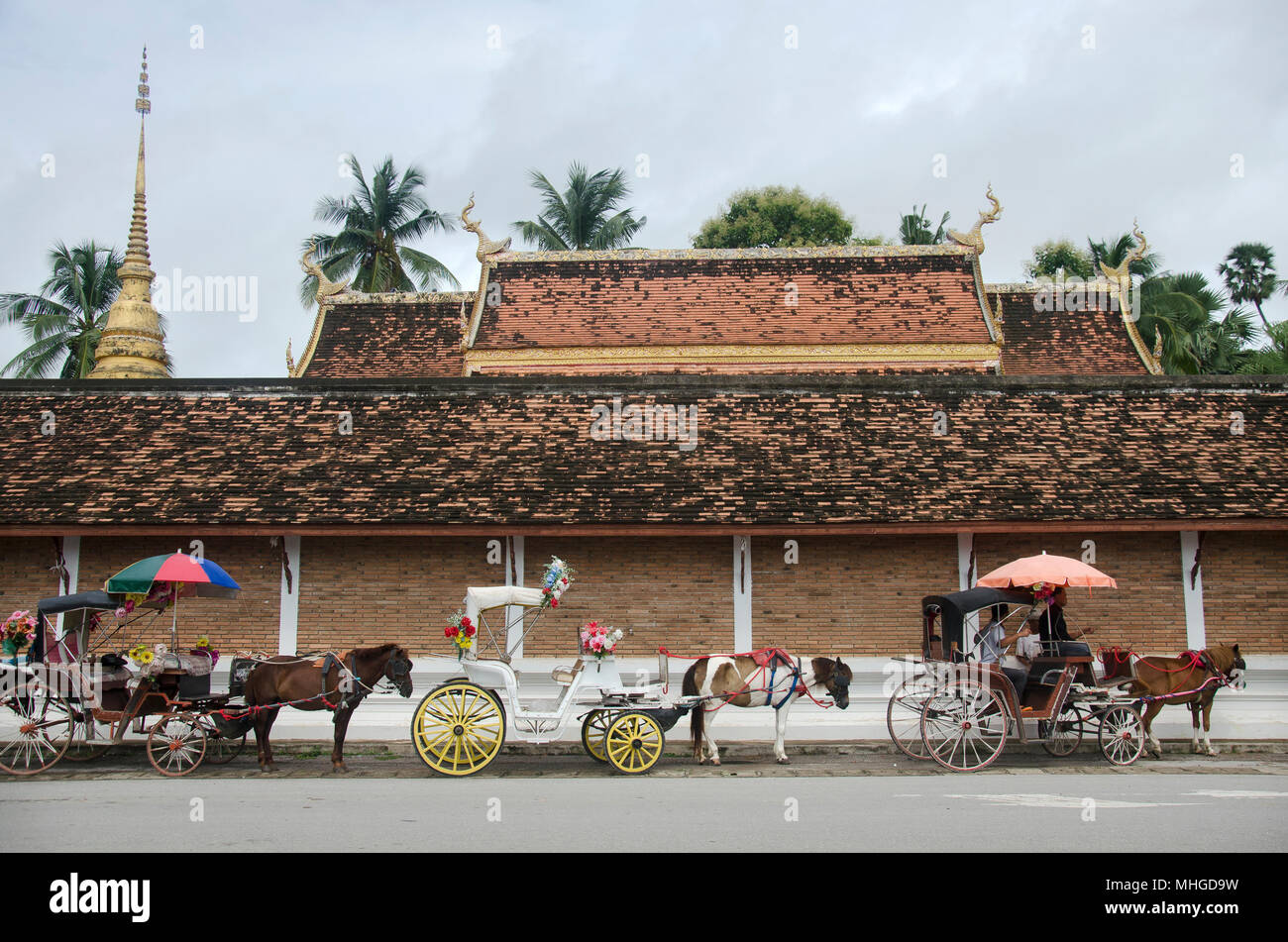 Popolo Thai e cavalli carrozza viaggiatori in attesa le persone utilizzano service tour città intorno al Wat Phra That Lampang Luang tempio sulla luglio 18, 2017 in Foto Stock