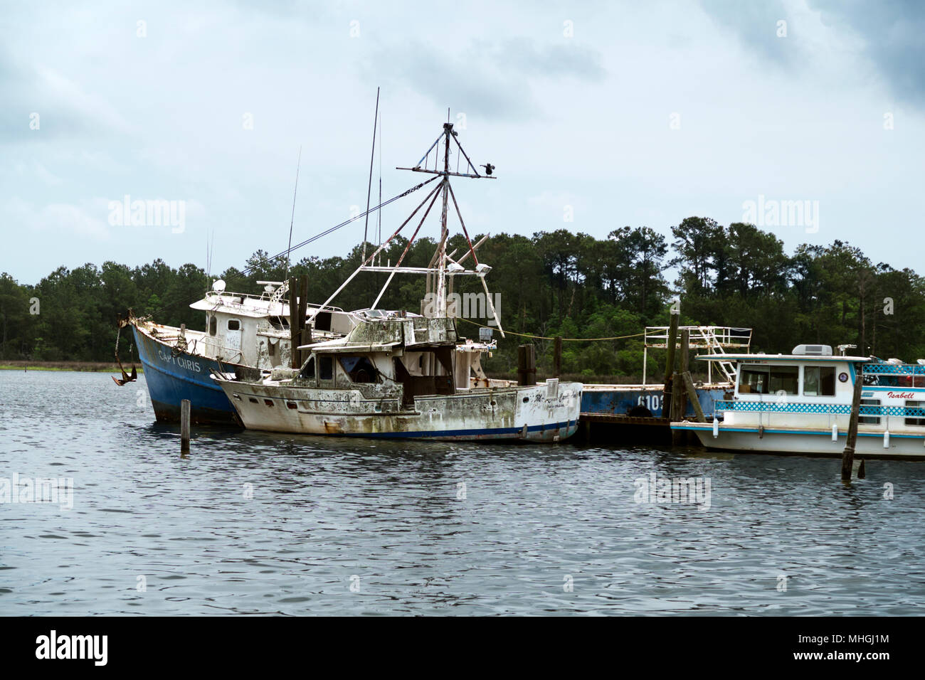 Tempesta danneggiato seduta barche abbandonate al dock sul Bon Secour River, Foley Alabama. Foto Stock