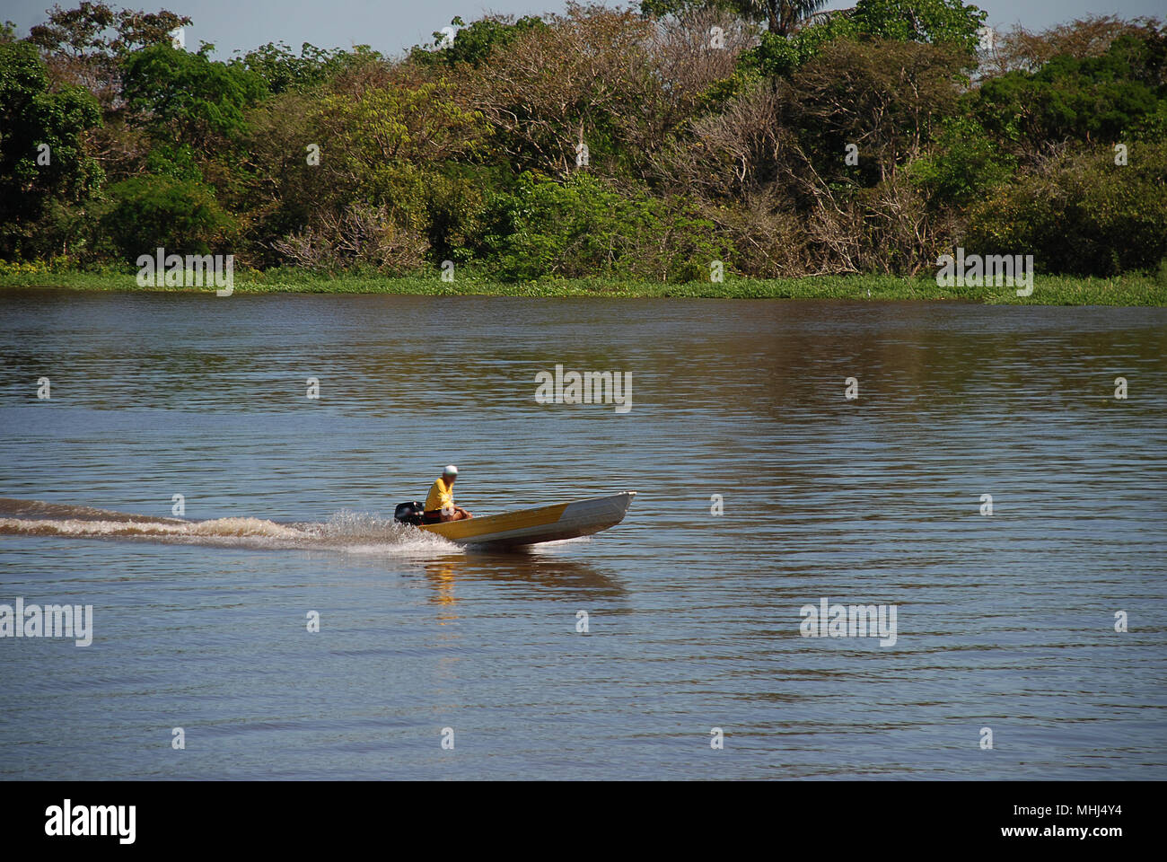 Un abitante di un villaggio che viaggia lungo il fiume Amazon vicino a  Manaus in una barca a motore Foto stock - Alamy