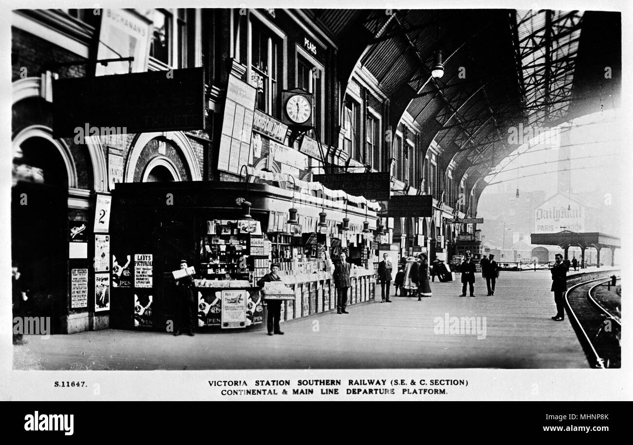 Stazione ferroviaria meridionale continentale e mainline partenza piattaforma 2 nella stazione di Victoria di Londra, con una W H Smith news stand. Data: circa 1910 Foto Stock