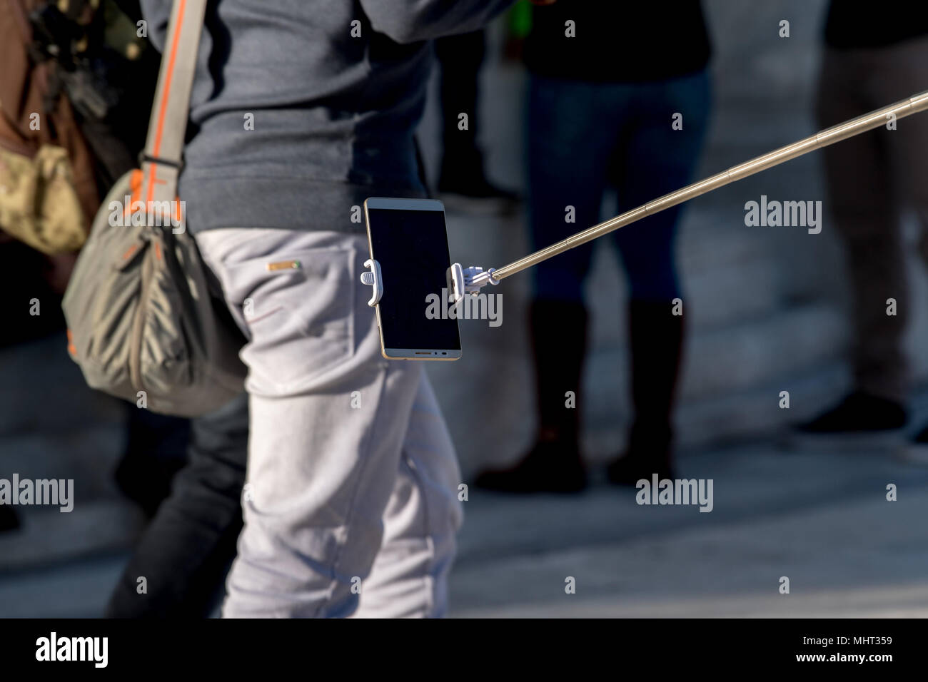 Selfie utilizzando il telecomando e la prolunga treppiede Foto Stock