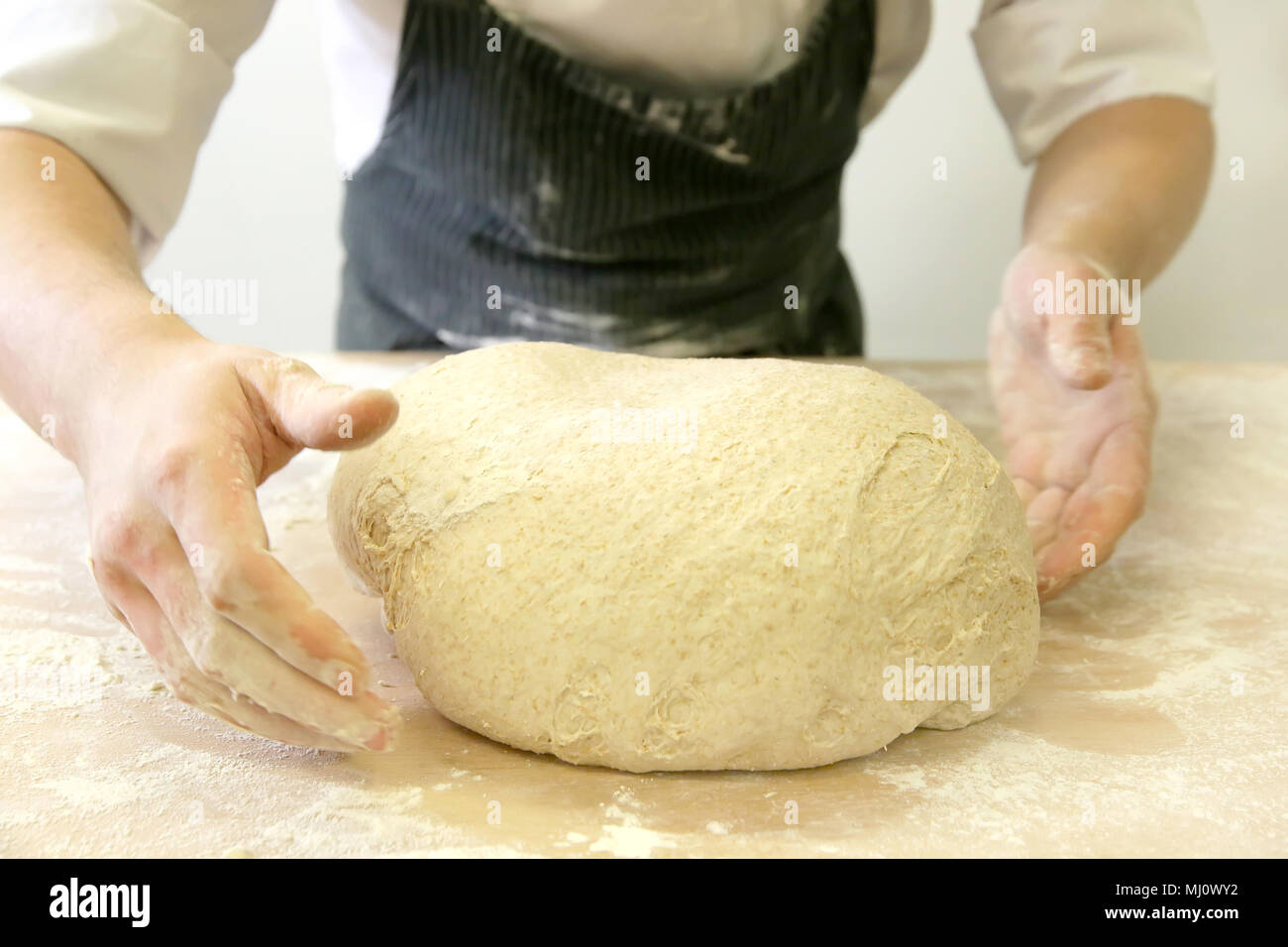 Produrre un impasto da mani maschio al forno Foto Stock