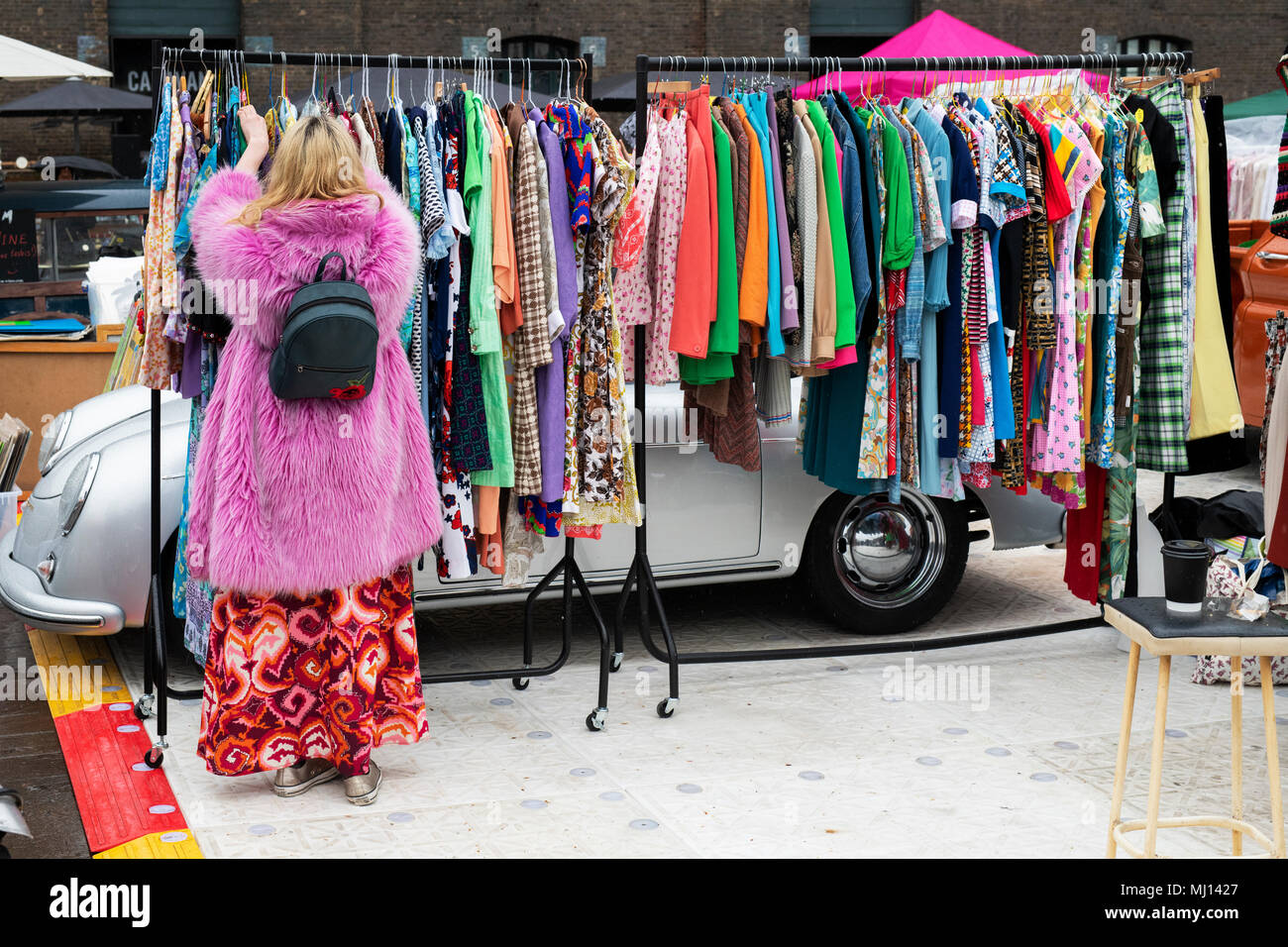 Vecchio vintage abiti femminili per la vendita su un rack a un retro vintage auto vendita di avvio. Granary Square, Kings Cross, London Foto Stock