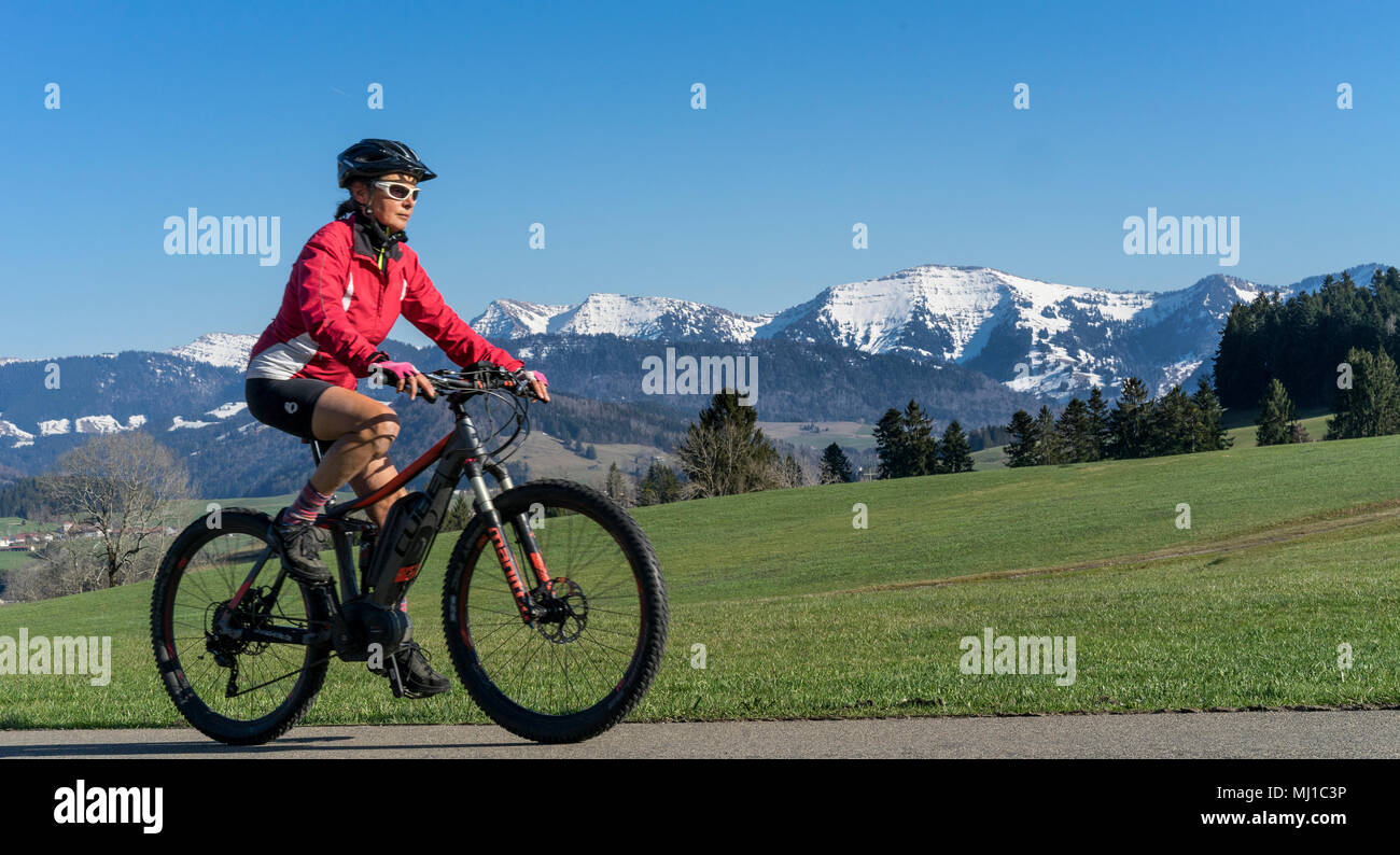 Senior donna mountainbike in primavera nella zona Allgaeu, Tedesco alpes Foto Stock