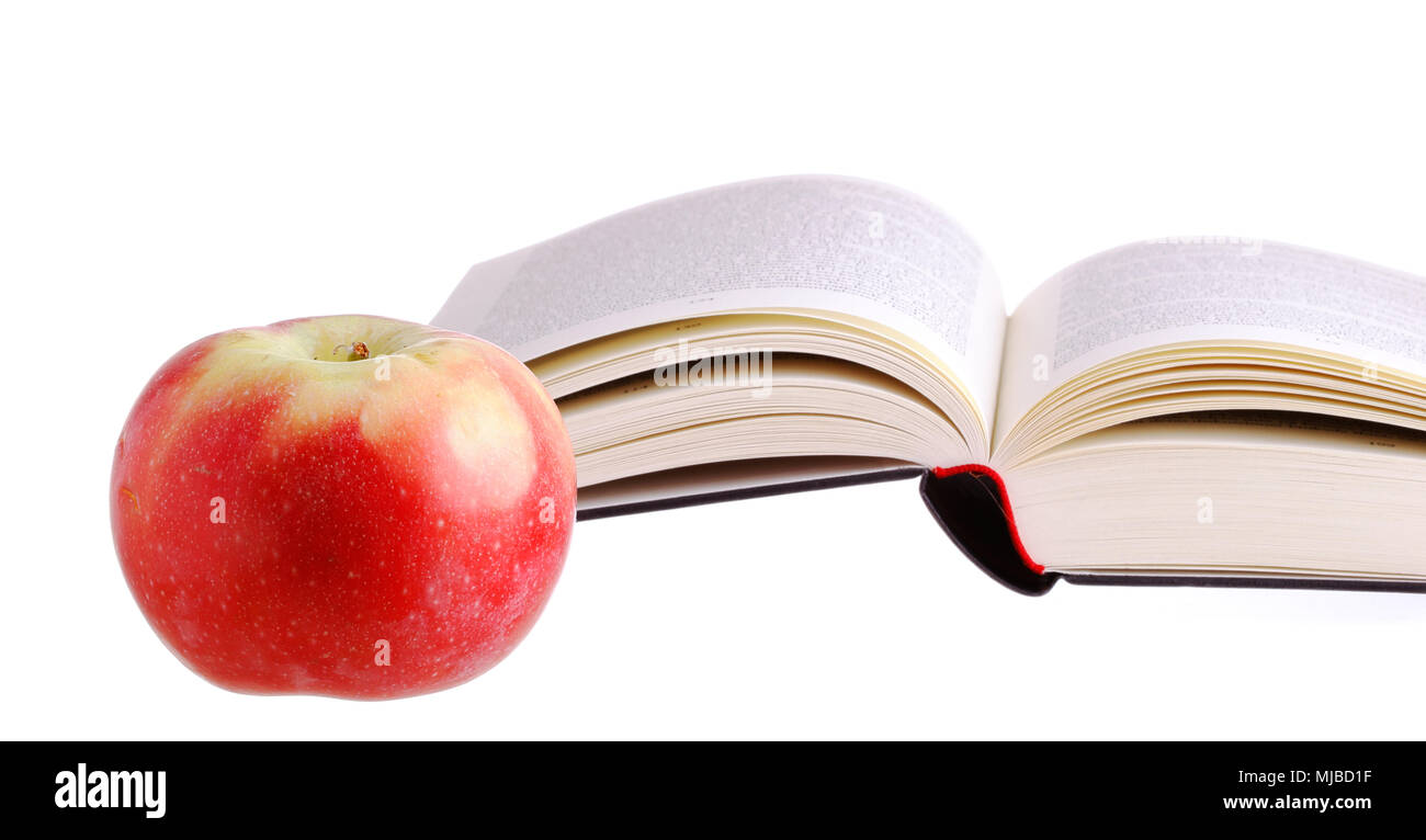 La mela di saggezza a lato di un libro. Foto Stock