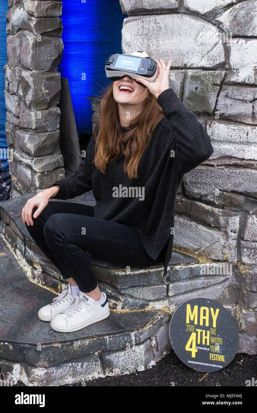 Donna che indossa la realtà virtuale auricolare per visualizzare le Skellig Rocks, nella contea di Kerry, Irlanda dall' isola Valentia Visitor Center, organizza per Failte Ireland Tourism, durante il mese di maggio la quarta banca weekend di vacanza Foto Stock