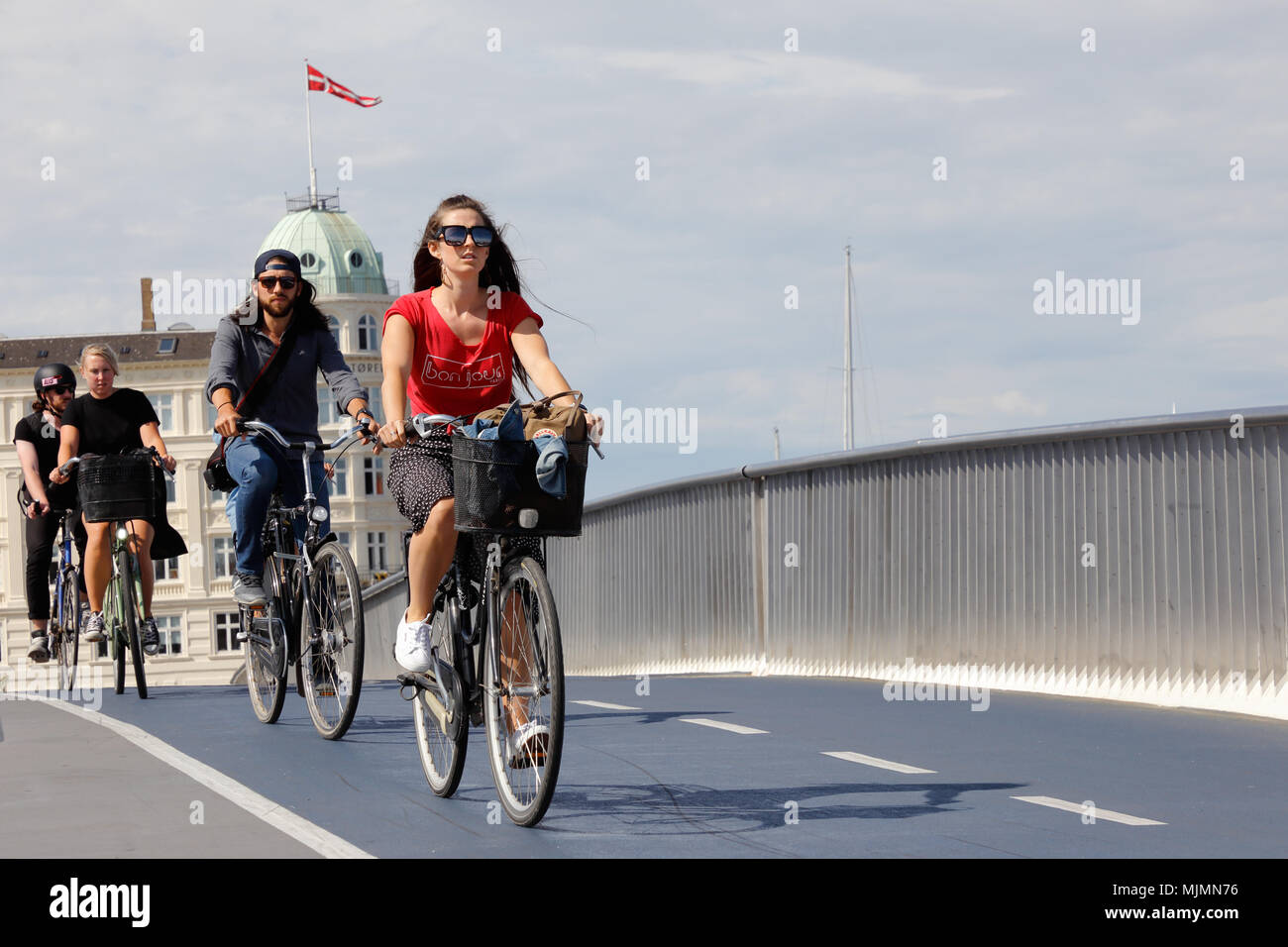 Copenhagen, Danimarca - 24 agosto 2017: un gruppo di tre cicli di ciclisti oltre il ponte Inderhavnbroen. Foto Stock