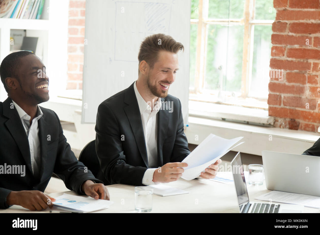 I lavoratori di sesso maschile analizzando i rapporti di cordiale atmosfera di office Foto Stock
