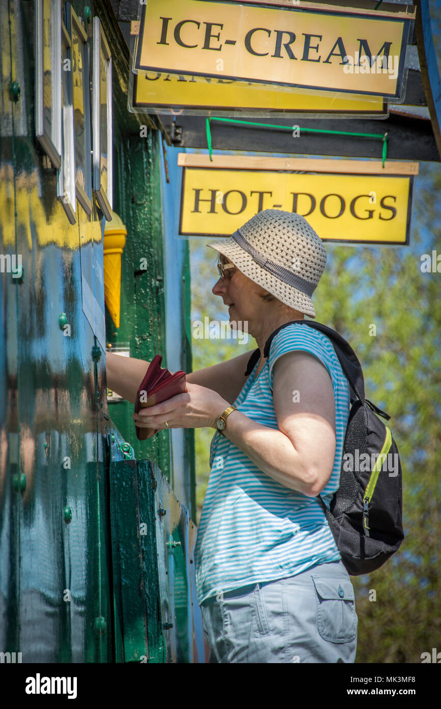 Donna con 99 gelati su una calda giornata di sole Foto Stock