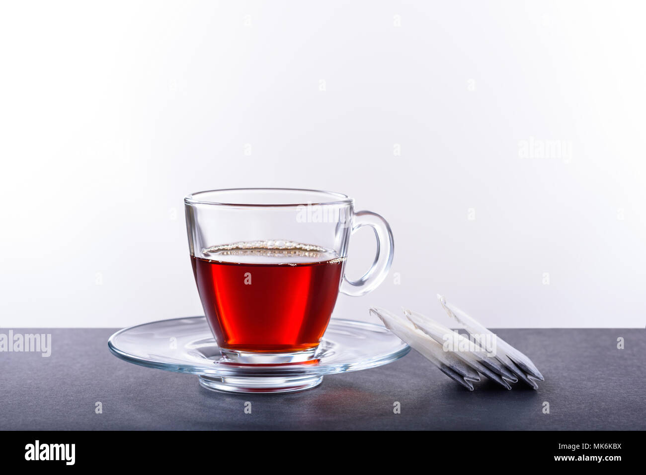 Tazza e piattino con tè su sfondo bianco Foto Stock