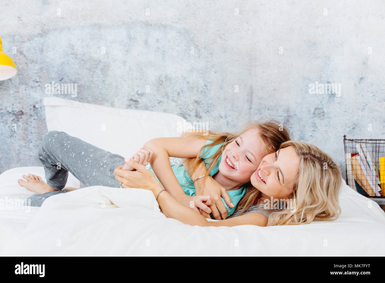 Bella madre e figlia coccola fino a letto Foto Stock