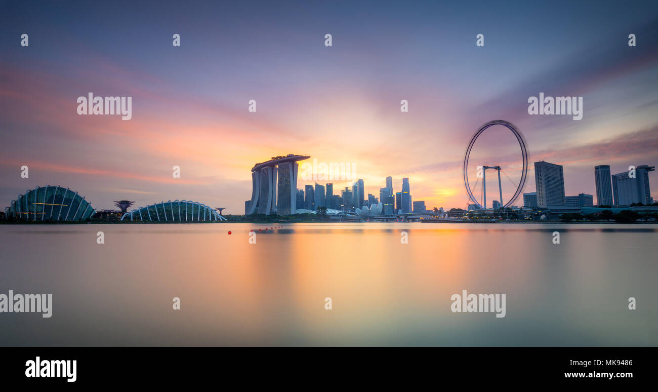 Lo skyline di Singapore e la vista dei grattacieli su Marina Bay al tramonto Foto Stock