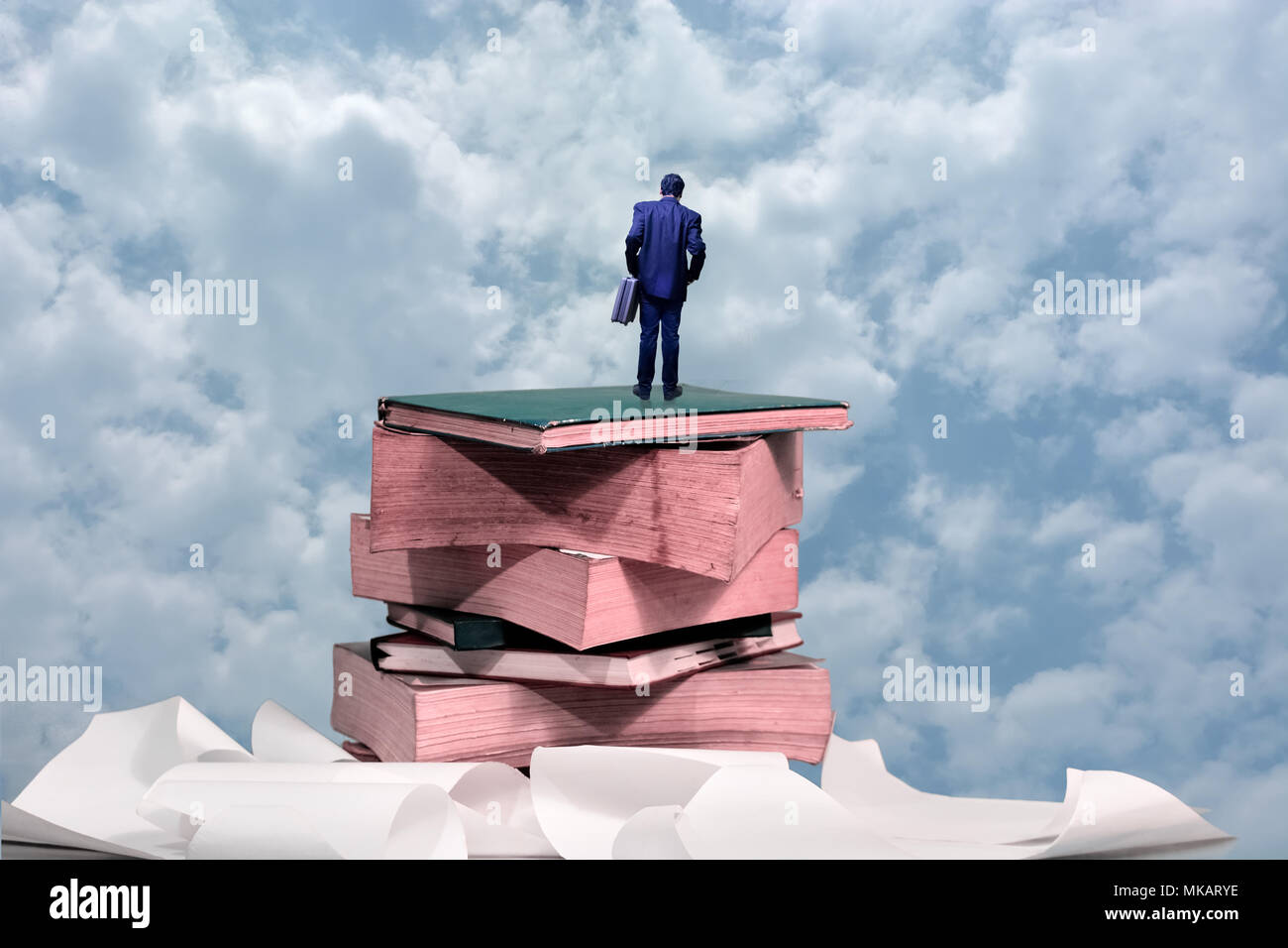 Business man in piedi sulla parte superiore dei libri Foto Stock