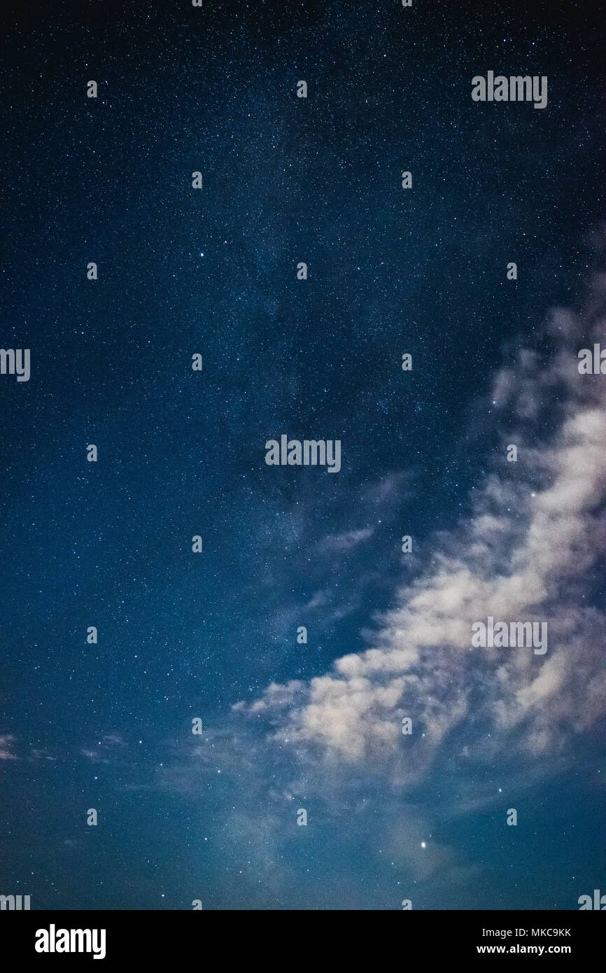 Di notte il cielo stellato con la Via Lattea e le nuvole in estate Foto Stock