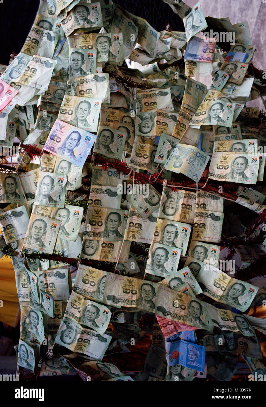Denaro - la moneta Thai Baht in prostitute tempio Wat Kanikapon nella Chinatown di Bangkok in Thailandia nel sud-est asiatico in Estremo Oriente. Corsa di beneficenza Foto Stock