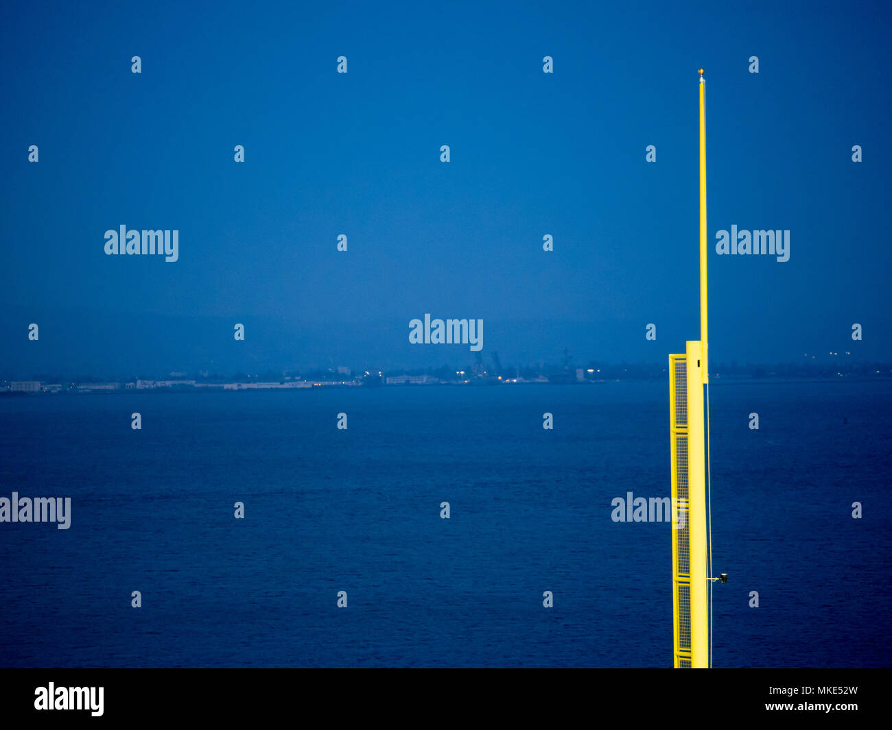 Un baseball fallo pole che si affaccia su un corpo di acqua durante la notte Foto Stock