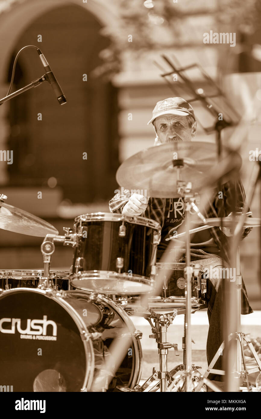 DIMITROVGRAD, Bulgaria - 30 Aprile 2018: Maschio il batterista suona la musica all'aperto mentre guardando nella telecamera a street concerto evento dedicato al mondo internazionale Jazz giorno Foto Stock