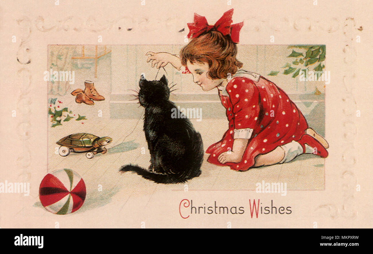 Scheda di Natale con la ragazza che gioca con Cat Foto Stock