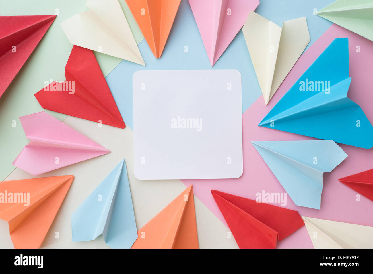 Carta colorata e aereo vuoto bianco carta memo pad sul pastello colorato sfondo. memo,elenco,organizzare e aria concetto di posta Foto Stock