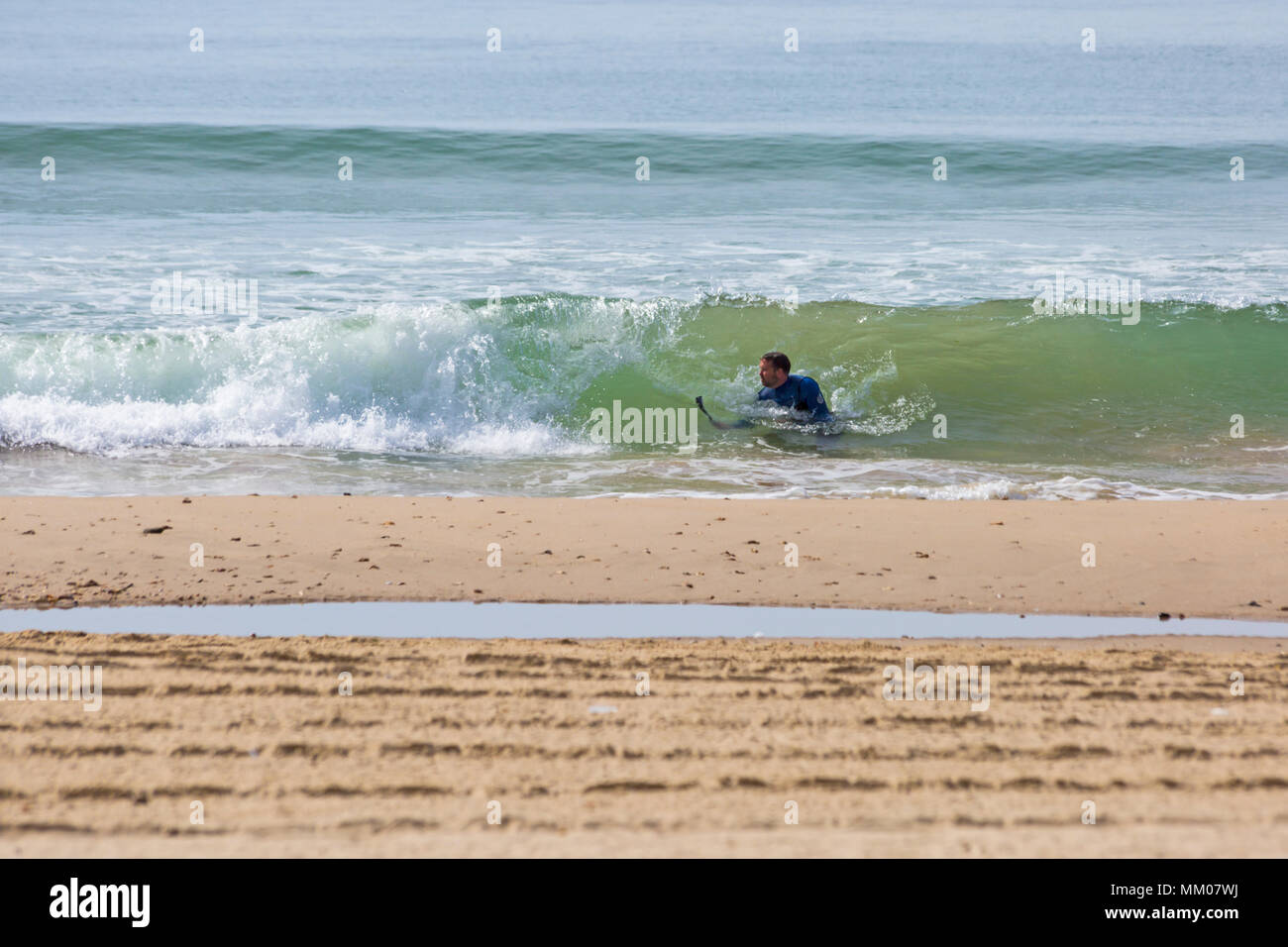 Bournemouth Dorset, Regno Unito. Il 9 maggio 2018. Regno Unito: meteo sole caldo per iniziare la giornata, come testa di visitatori alla spiaggia. Uomo di scattare le foto delle onde del mare che si elevano al di sopra di lui a Bournemouth Beach. Credito: Carolyn Jenkins/Alamy Live News Foto Stock