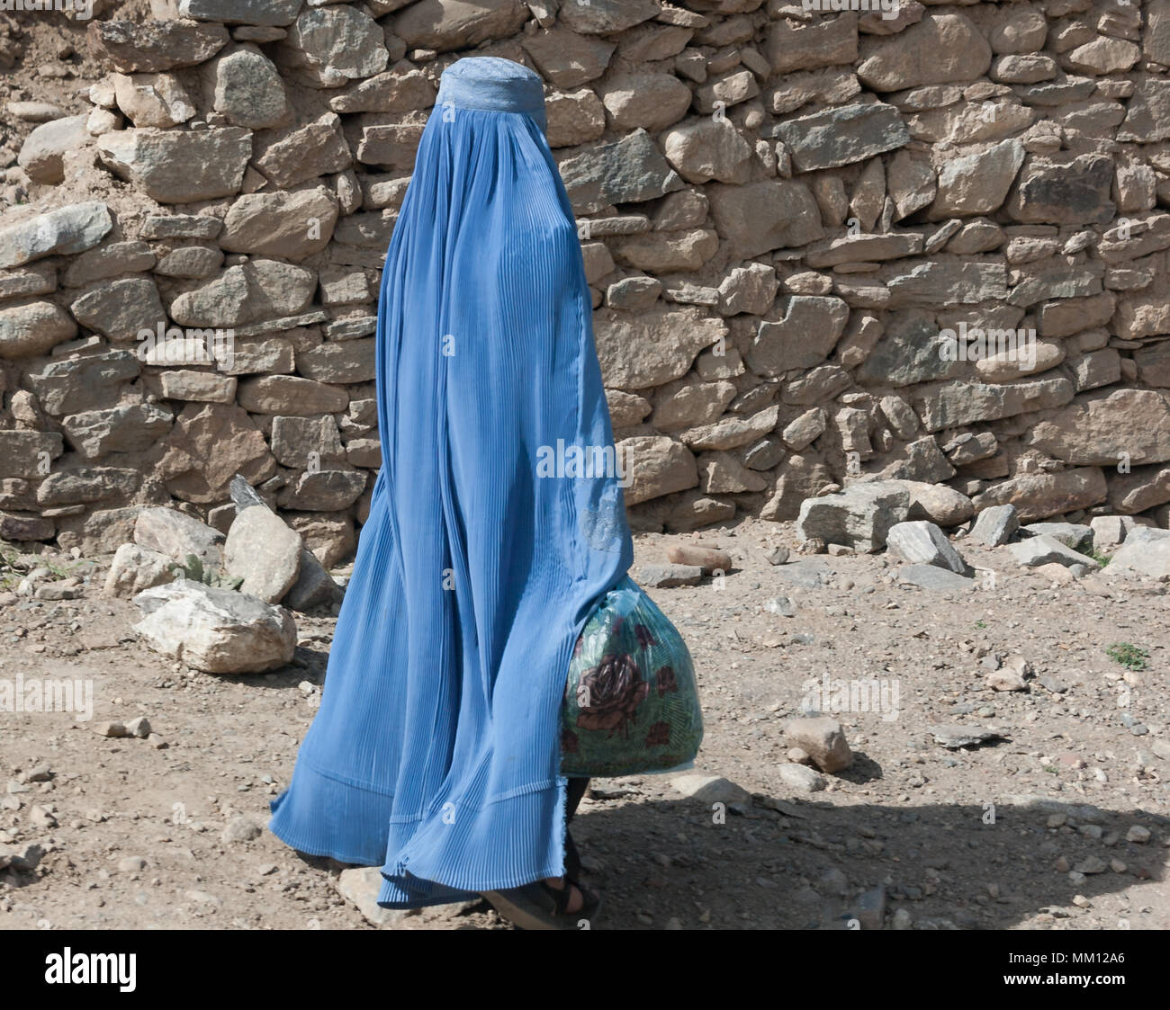 Donna che cammina per le strade di Kabul in burqa Foto Stock