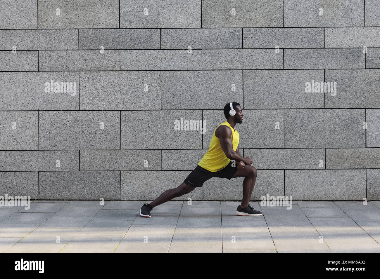 Fitness e concetto di salute. Afro American pareggiatore di fare stretching dopo allenamento mattutino. Foto Stock