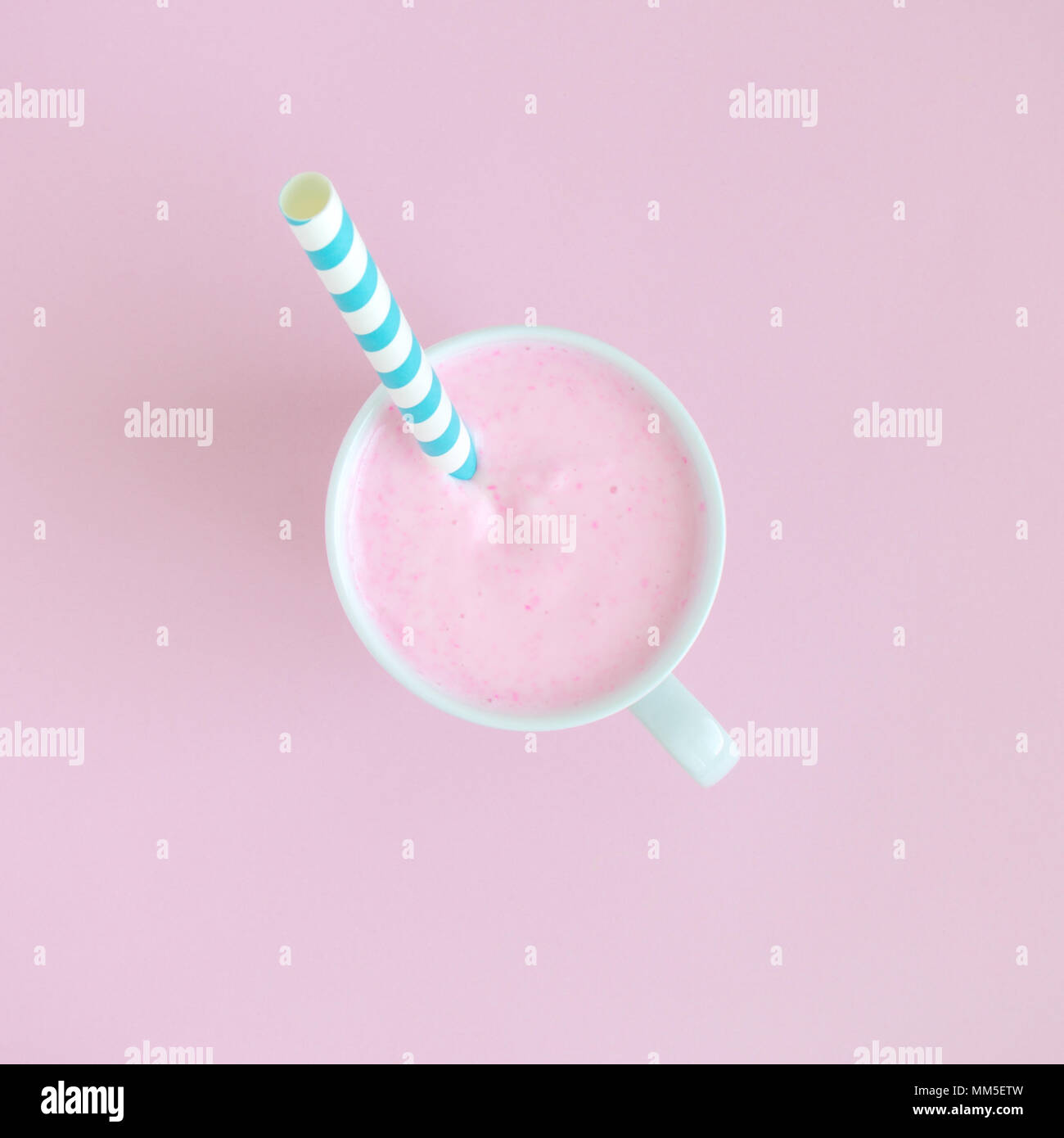 Piatto di laici smoothie con cannuccia contro di rosa pastello minima di sfondo concetto creativo. Foto Stock