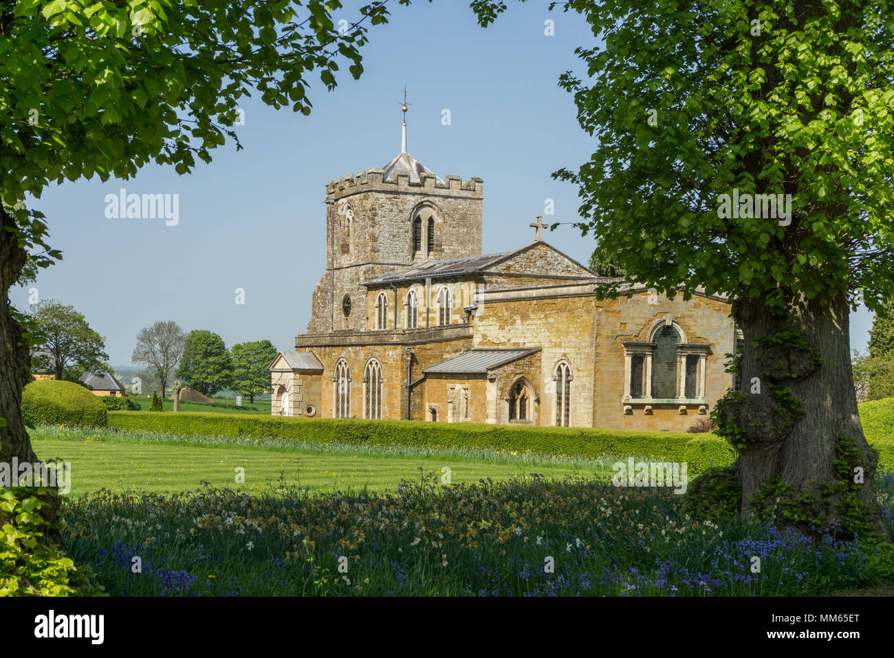 La chiesa di Tutti i Santi come visto dalla motivazione di Lamport Hall, Northamptonshire, Regno Unito; le parti più antiche della chiesa risalgono al XIII secolo. Foto Stock