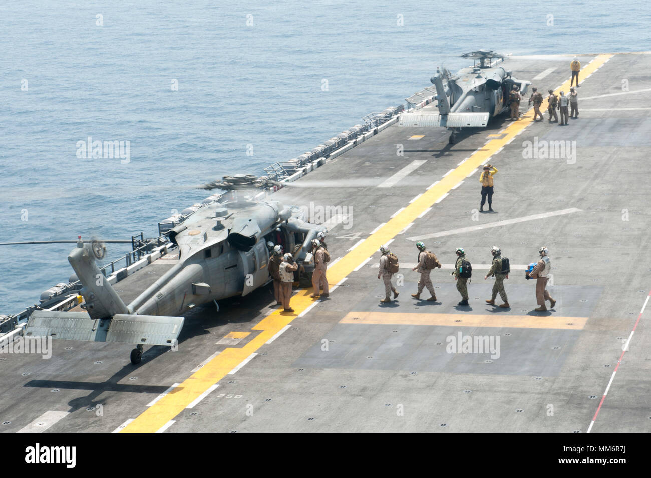 170908-N-ZS023-014 U.S. 5TH FLOTTA AREA DI RESPONSABILITÀ (sett. 8, 2017) Marines assegnato al XV Marine Expeditionary Unit (XV MEU) bordo un MH-60S Sea Hawk elicottero assegnato al "Jolly" di elicottero di mare squadrone di combattimento (HSC) 23 sul ponte di volo dell'assalto anfibio nave USS America (LHA 6) prima di condurre una visita, scheda, ricerca e sequestro di formazione missionaria a sostegno dell esercizio del coccodrillo di pugnale 2017. Alligatore pugnale è un dedicato, unilaterale prove di combattimento guidato da Naval Amphibious vigore, Task Force 51/5th Marine Expeditionary Brigade, in cui Marina combinato un Foto Stock